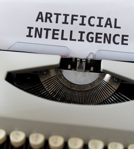 image of an older typewriter with 'Artificial Intelligence' in large bold letters.